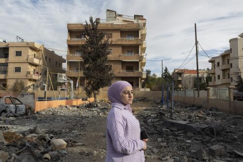Palestinian refugee Malak Sabah stands amongst rubble in front of the building where her sister lives and that was damaged by Israeli bombardment of buildings nearby in the city of Baalbek, Lebanon. 