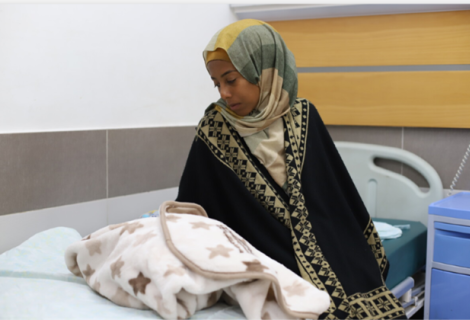 Umm Fulan, a new mother who has just given birth at Al-Awda Hospital. 